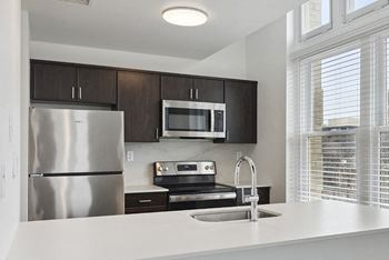 a kitchen with a sink and a refrigerator